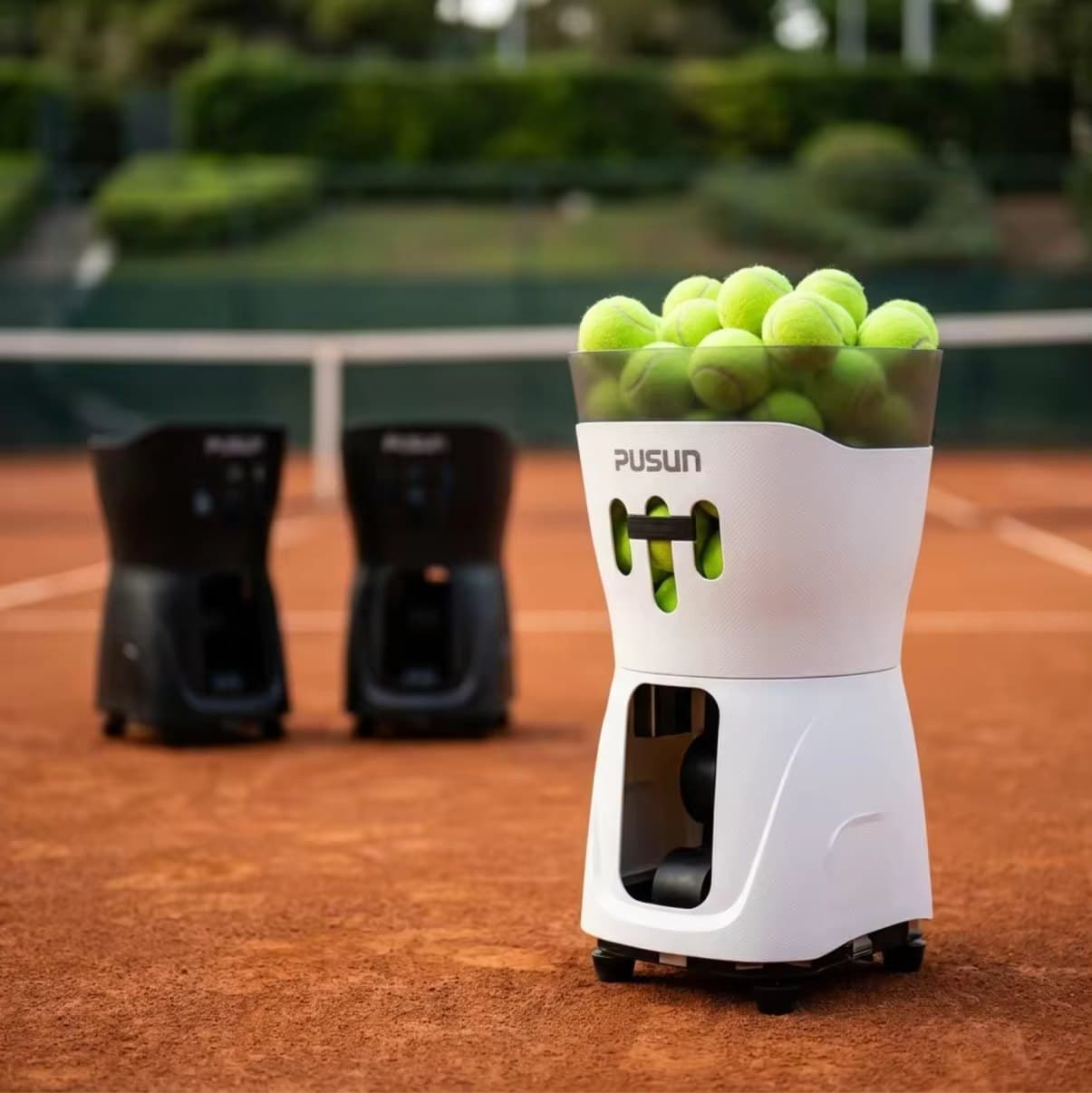 The Pusun PT-Mini Pro ball machine loaded with balls, on court